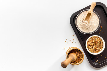 Pestle buckwheat flour - grains with mortar on kitchen table