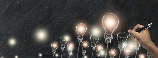 light bulb Chalk drawing on black chalkboard in Business design and copy space for text,
electric...
