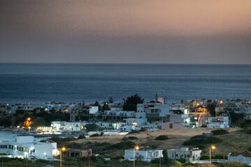 Cityscape on coastline of sea at dusk