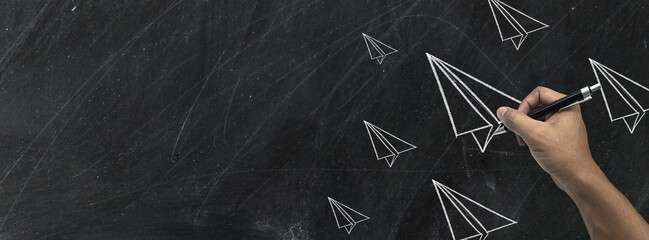 Hand drawing Rocket with chalk on blackboard,message concept written by chalk.