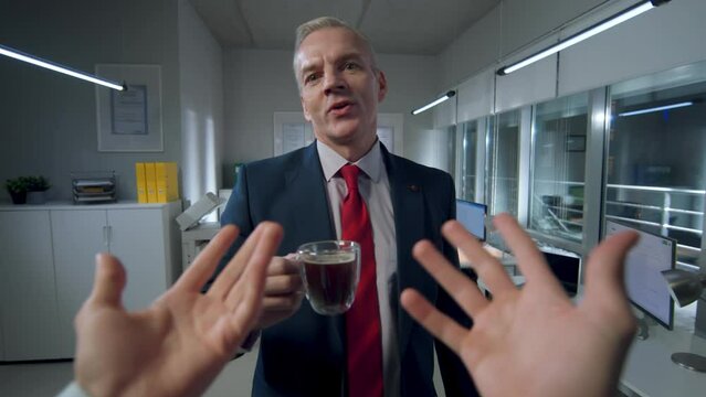 POV shot of man gesturing hands and talking to colleague in office