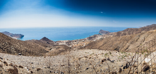 Landscape with sea viewed from hill on sunny day