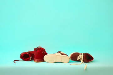 new burgundy sneakers on the table. concept design. copy space.