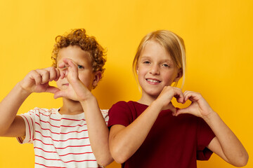 picture of positive boy and girl casual wear games fun together on colored background