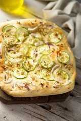 Homemade pizza with courgette and red onion