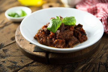 Homemade beef ragout with fresh basil