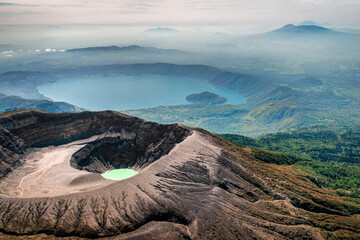 Aerial view of Santa Ana Volcano with lake and mountain cloud backdrop