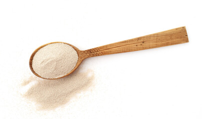Dry yeast in wooden scoop isolated on white background
