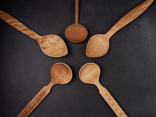 handmade wooden spoons on a dark background