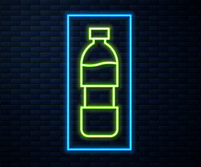 Glowing neon line Bottle of water icon isolated on brick wall background. Soda aqua drink sign. Vector