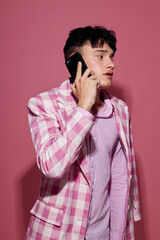 handsome guy self confidence pink plaid blazer fashion posing pink background unaltered