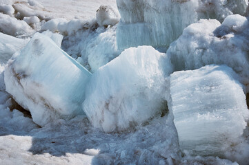Melting ice floes in spring. A heap of blocks and fragments. Ice drift on the Amur River. Sunny day. Drifted ice pieces. © Алексей Игнатов