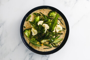 vegan green curry with broccoli cauliflower and green beans, healthy plant-based food