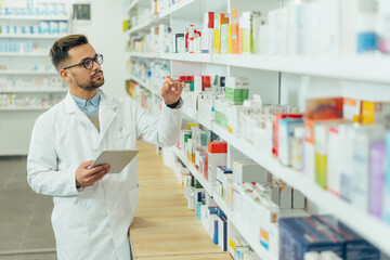 Portrait of a handsome pharmacist working in a pharmacy