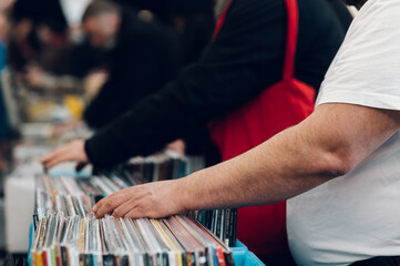 Man hands browsing vinyl album in a record store