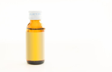 Amber glass bottle of liquid medicine with yellow cap isolated on white background