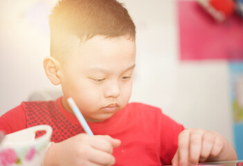 child writing in notebook for school