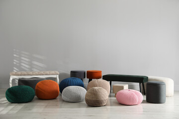 Obraz premium Many stylish different poufs and benches indoors. Home design