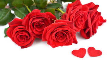 Red rose bouquet with red felt hearts on white background. Soft focus. Greeting card. Space for your text