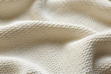 Beautiful white knitted fabric as background, closeup