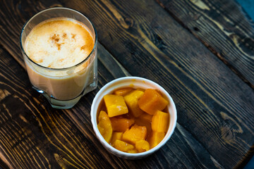 Yellow Indian mango yoghurt drink Mango Lassi or smoothie with turmeric and saffron.