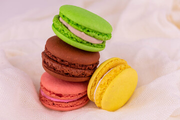Colorful French macarons on a white background.