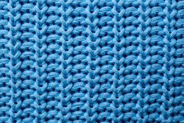 Naklejka na ściany i meble Beautiful light blue knitted fabric as background, top view