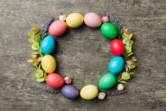 round frame Multi colors Easter eggs on colored background . Pastel color Easter eggs holiday concept with empty space for you design