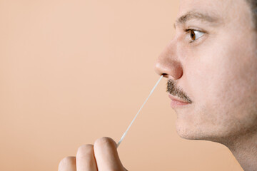 Man using nasal swab for Covid-19 testing - obrazy, fototapety, plakaty