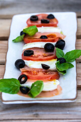 mozzarela as a caprese salad with black olives