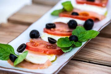 mozzarela as a caprese salad with black olives