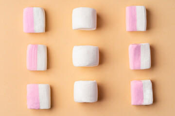 Fluffy marshmallows on beige studio background, top view