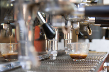 Close-up of espresso pouring from the coffee machine. Professional coffee preparation