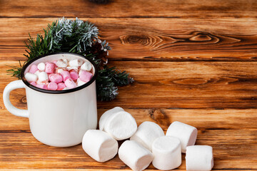 Cup of hot cocoa with marshmallows on wooden background