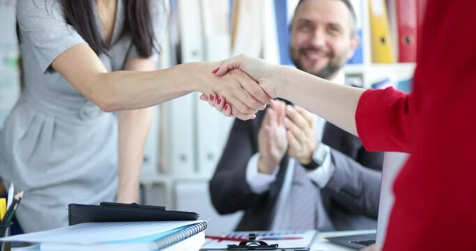 Businesswoman makes handshake at business meeting closeup