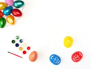 Do it yourself set for painting easter eggs with stencils, tassel, paints and eggs on white background. Happy Easter concept. Process of crafting. Flat lay style with copy space