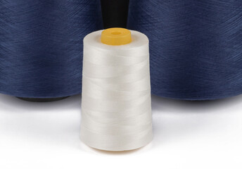 Spool of sewing thread, isolated on white background. Colored yarns used by factories in the clothing industry. Threads wound on the spool. Colored reels