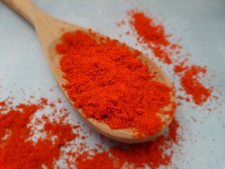 Paprika, in a wooden spoon. It is a spice widely used in the kitchen as a condiment, obtained from...