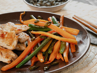 dish of chicken and vegetable: carrots and green beans. Healthy food, meal with proteins and vegetable.  oriental food