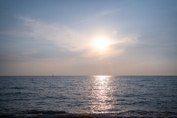 golden sunset or sunrise at the deep dark ocean. aerial view of sundown and up to the sea. yellow and orange colorful sky.