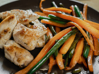 dish of chicken and vegetable: carrots and green beans. Healthy food, meal with proteins and vegetableclose up oriental food