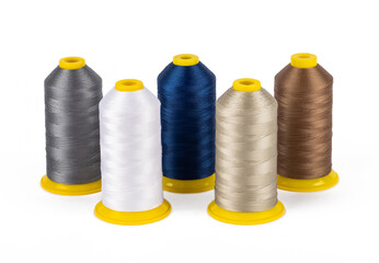 Spool of sewing thread, isolated on white background. Colored yarns used by factories in the clothing industry. Threads wound on the spool. Colored reels