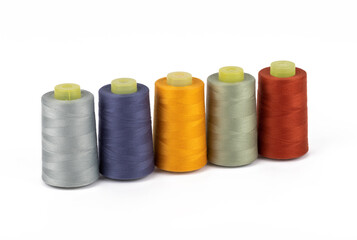 Spool of sewing thread, isolated on white background. Colored yarns used by factories in the clothing industry. Threads wound on the spool. Colored reels