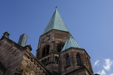 Upper part of Apostelkirche protestant church under a blue winter sky, concept of religion, Christ, holiness, resurrection and worship (horizontal), Kaiserslautern, Rhineland Palatinate, Germany