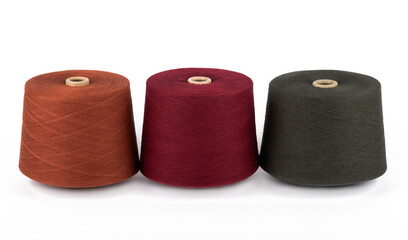 Spool of sewing thread, isolated on white background. Colored yarns used by factories in the clothing industry. Threads wound on the spool. Colored reels