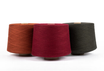 Spool of sewing thread, isolated on white background. Colored yarns used by factories in the clothing industry. Threads wound on the spool. Colored reels