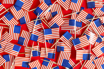 Fototapeta premium American flags flat lay on the red background. USA national day USA celebration.