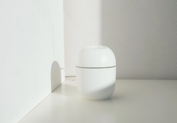 The humidifier is powered by USB on a white background with bright sunlight. Mini diffuser on  white background. 
