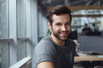 Fototapeta premium Smiling caucasian business man looking at camera