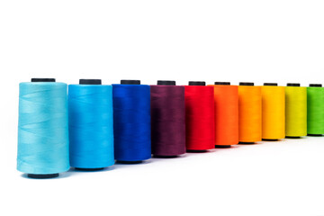Spool of sewing thread, isolated on white background. Colored yarns used by factories in the clothing industry. Threads wound on the spool. Colored reels